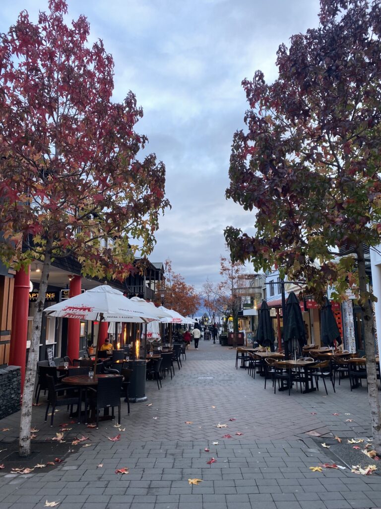 A photo of outside tables down a street in Queenstown