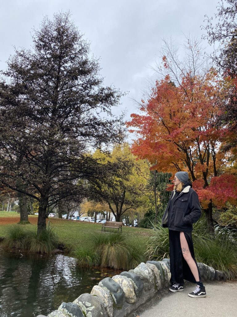 Jess stood on a bridge admiring the views in Queenstown Botanical Gardens