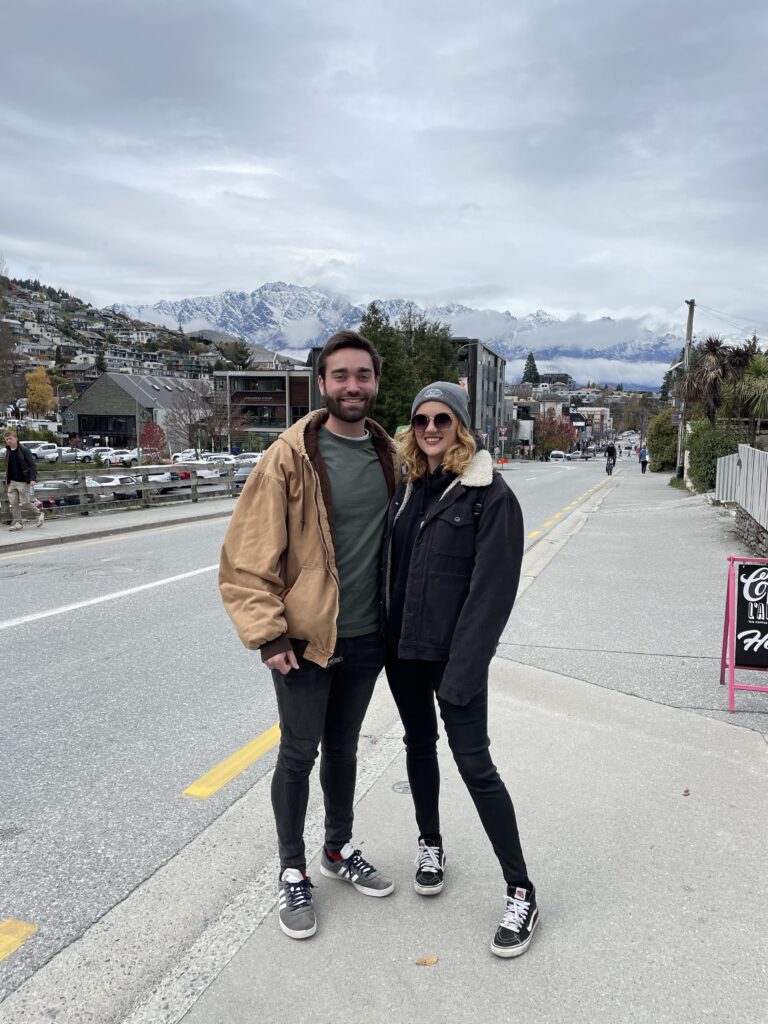 Ben (left) and Jess (right) pictured with the Queenstown mountains in the distance