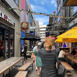 Jess photographed from behind as she walks through Riverside Market in Central Christchurch, New Zealand.