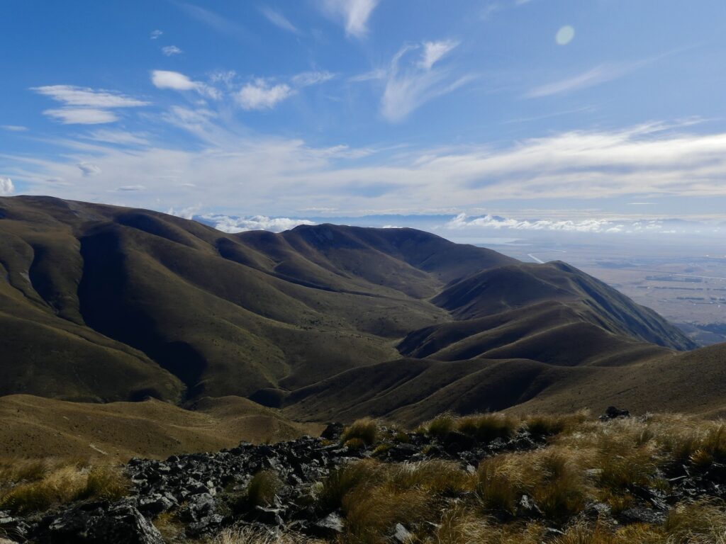 the view inside of the valley and mountain range where you can see the stretch of the path and hills.