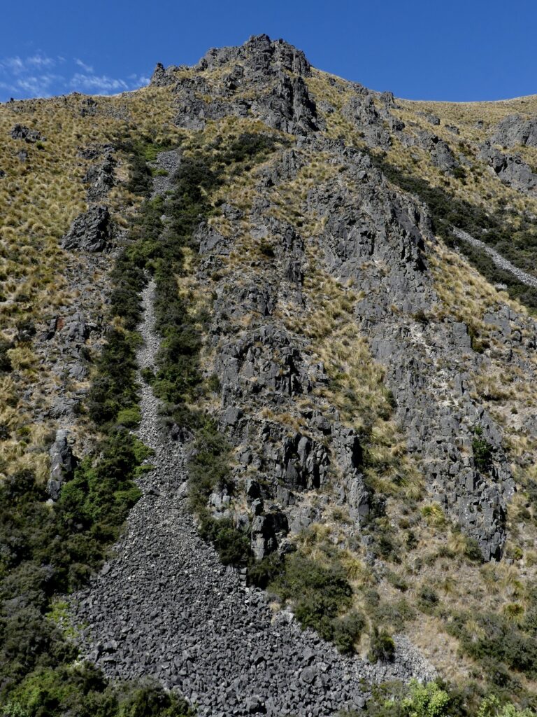 rocky bit of a hill with blue sky