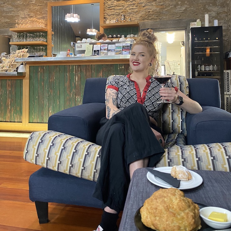 A photo of Jess in a cafe in Central Otago.